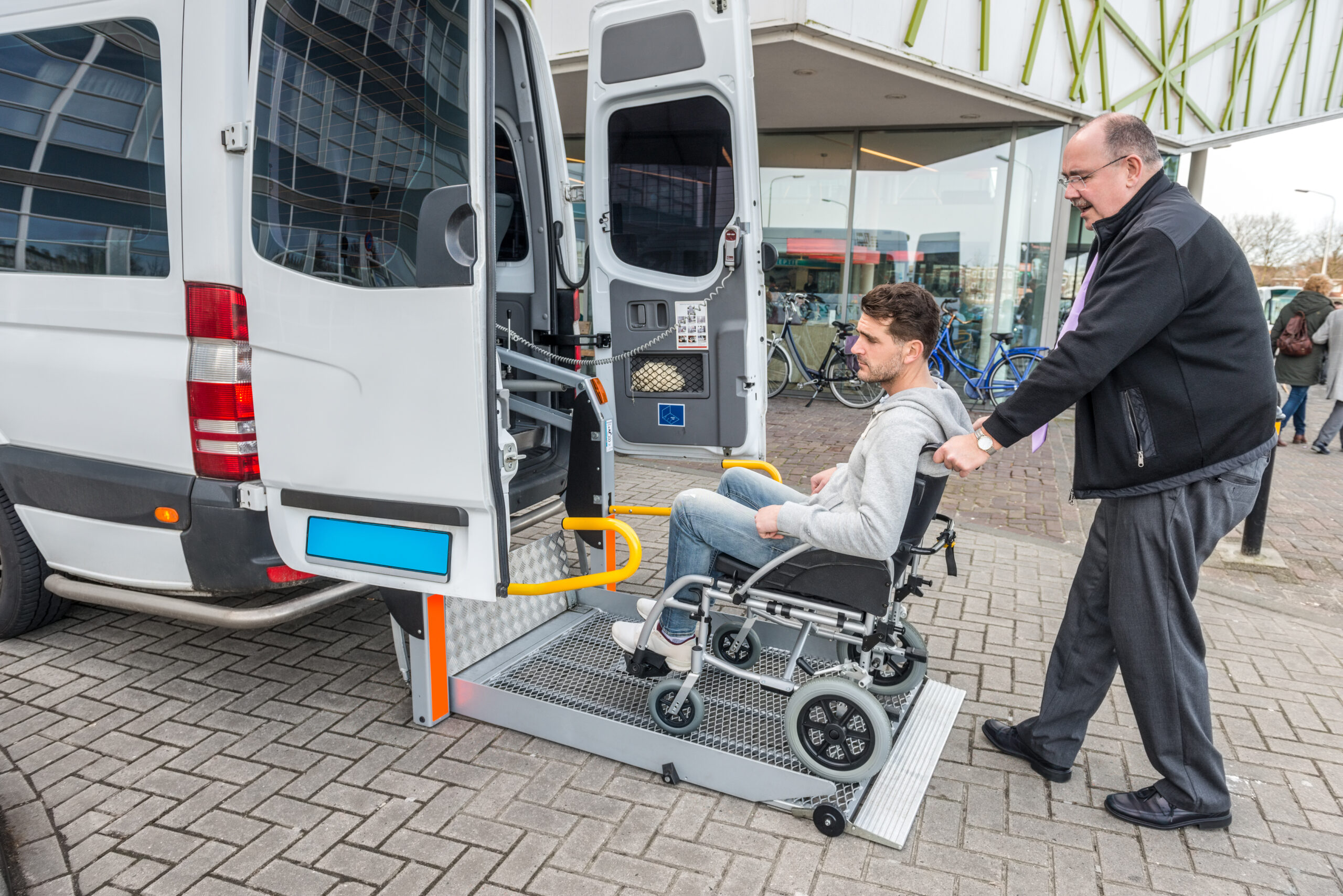 A man being assisted inside a van