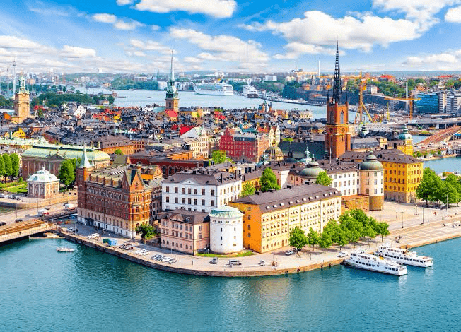 Aerial view of Stockholm showcasing historic architecture, vibrant buildings, and waterways, highlighting the city's scenic beauty and cultural significance.